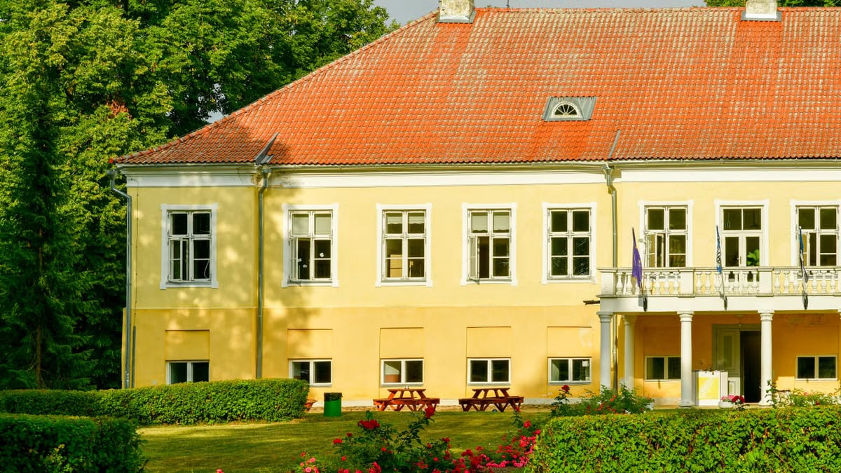 A charming yellow historical estate surrounded by lush greenery in Vasta, Lääne-Viru County, Estonia.